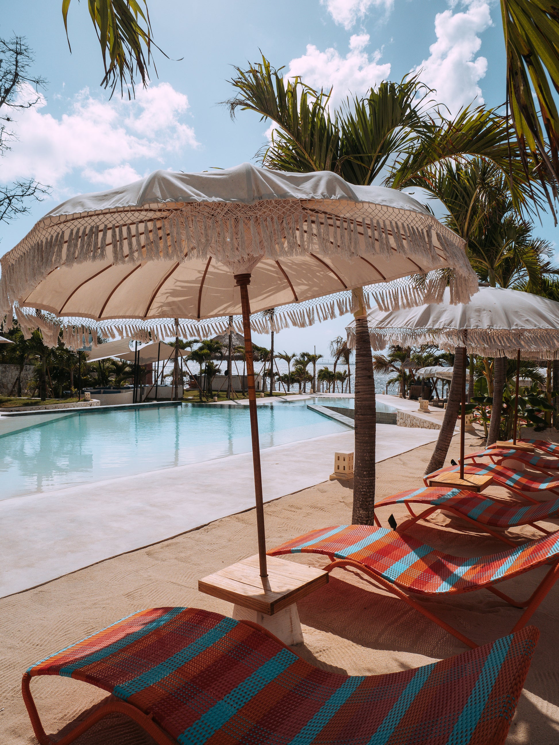 Cactus Beach Club in Nusa Penida Island Bali - poolside views with beach chairs and umbrella